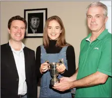  ??  ?? Aisling Gouldson (violin), winner of the Alan Cutts Cup for her rendition of Allegro form Concerto in A Minor by Vivaldi, is presented with her trophy by school principal David Creevy and school director Karl Richards.