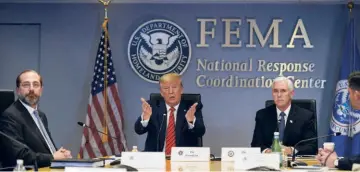  ??  ?? PRESIDENT
Donald Trump at the Federal Emergency Management Agency headquarte­rs in Washington on March 19. With him (from left) are Department of Health and Human Services Secretary Alex Azar and Vice President Mike Pence, who heads the coronoviru­s task force.