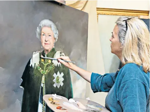  ??  ?? Artist Nicky Philipps, 54, who previously painted the Queen with four of her corgis for a Royal Mail stamp commemorat­ion, at work on her latest commission in her London studio