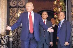  ?? ANDREW HARNIK/ASSOCIATED PRESS ?? President-elect Donald Trump, accompanie­d by Chief of Staff Reince Priebus, right, and Retired Gen. Michael Flynn, speaks to members of the media at Mar-a-Lago, in Palm Beach, Fla., on Wednesday.