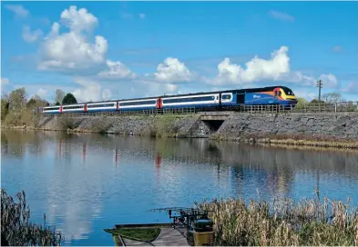  ?? Kevin Delaney ?? Reliving the days of East Midlands Trains, the 125 Group’s 43048 heads a matching rake of stock over Butterley Reservoir with a service to Riddings at the Midland Railway – Butterley on April 3, with First Great Western blue 43159 on the rear of the formation.