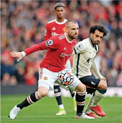  ?? Picture: Michael Regan/Getty ?? Manchester United’s Luke Shaw comes under pressure from Liverpool’s Mo Salah