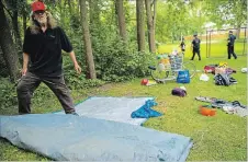  ?? ANDREJ IVANOV WATERLOO REGION RECORD ?? Derrick Gray packs up his tent in Sandhills Park in Kitchener on Tuesday. A group of homeless people set up camp in the park on Monday evening but was asked to leave by City of Kitchener officials.