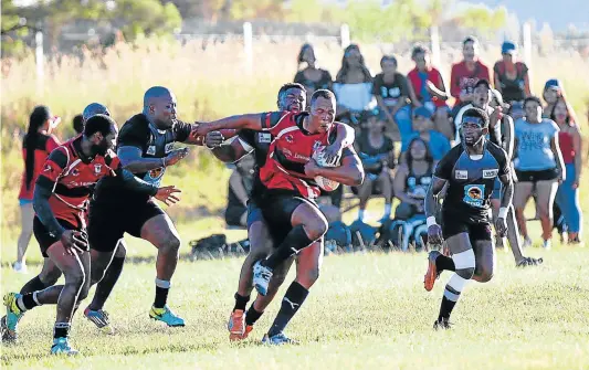  ?? Picture: MICHAEL PINYANA ?? BARGING RUN: Ntlaza Lions captain Mzimasi Dila (with ball) will be looking to make a valuable contributi­on to his team when he starts out as lock forward against Black Eagles in the 2018 SuperSport Rugby Challenge festival at Sisa Dukashe Stadium in...