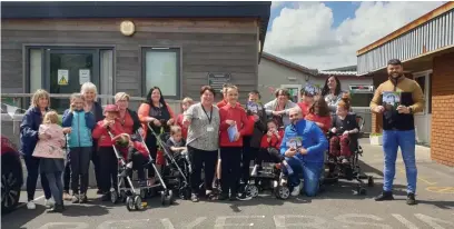  ??  ?? The book is also being sent to local schools and the children’s ward at Glangwili Hospital. Staff and pupils at the Myrddin Unit at Myrddin Primary School, Carmarthen, are pictured receiving their copies of the book.