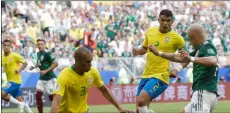  ??  ?? Mexico’s Javier Hernandez (right) is challenged by Brazil’s Miranda (left) and Brazil’s Thiago Silva (center) during the round of 16 match between Brazil and Mexico at the 2018 soccer World Cup in the Samara Arena on Monday AP PhoTo/Andre Penner