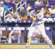  ?? Michael Reaves / Getty Images ?? Robinson Cano of the New York Mets singles in the ninth inning against the Miami Marlins at Marlins Park on Sunday in Miami. Cano went 4 for 5 for his first fourhit game since May 7.