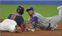  ?? DAVID DERMER — THE ASSOCIATED PRESS ?? Jose Ramirez slides into second for a double beating a tag from the Royals’ Alcides Escobar during the 10th inning on Sept. 14 at Progressiv­e Field.