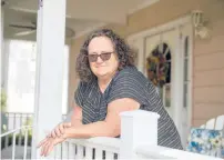  ?? KASSI JACKSON/HARTFORD COURANT ?? Karen Kingston stands on the front porch at her home Friday in Old Lyme. Kingston’s 98-year-old mother lives at Three Rivers Healthcare Center in Norwich, which the state Department of Public Health moved to close this past Wednesday after several residents died from COVID-19 and over two dozen others became infected. Kingston’s mother tested negative for the virus.