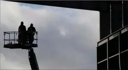  ?? CANADIAN PRESS FILE PHOTO ?? Workers rise in a lift at the Vancouver Shipyard. Statistics Canada said Friday the Canadian economy added 48,300 net new jobs in January.