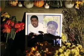  ?? Photograph: Ray Chavez/The Mercury News via Getty Images/MediaNews Group via Getty Images ?? A memorial for the victims of the recent Orinda shooting includes a photo of Raymon Hill Jr.