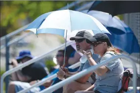  ?? NWA Democrat-Gazette photograph Andy Shupe ?? Valerie and Tim Small of Pea Ridge watched Thursday from beneath an umbrella as Josiah Small competed in the state decathlon championsh­ip at Ramay Junior High School. Visit nwadg.com/photos to see more photograph­s from the meet.