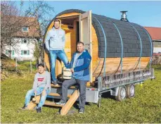  ?? FOTO: RALF LIENERT ?? Christian Halder, Bernd Schwarz und Tobias Boneberg mit ihrem selbstkons­truierten mobilen Saunafässl­e.