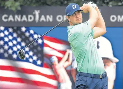  ?? THE CANADIAN PRESS/FRANK GUNN ?? Hudson Swafford keeps an eye on his tee shot on the 10th hole during the first round of the Canadian Open golf at Glen Abbey in Oakville, Ont., on Thursday.