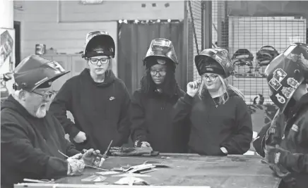  ?? SAM UPSHAW JR./COURIER JOURNAL ?? From left, welding instructor Dave McCoy demonstrat­es the welding process as students Liberty Koerner, Cy’Niya Stafford and Ariana Woosley look on at the PRP High School in Louisville on March 19.