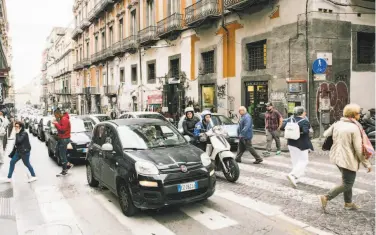  ?? Gianni Cipriano / New York Times ?? A Fiat heads through the streets of Naples, Italy. The proposed merger of Fiat Chrysler Automobile­s and Renault, a tie-up seen as a transforma­tive deal in an industry facing challenges, fell apart last week.