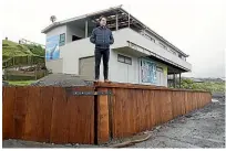  ??  ?? John Wesley-Smith standing on the new seawall at Titahi Bay Surf Life Saving Club. The club has been dealing with erosion since a storm last year.