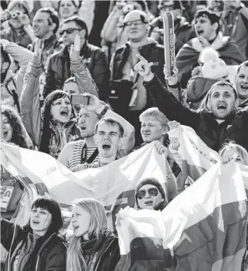  ?? JACK GRUBER, USA TODAY SPORTS ?? Russian fans cheer at the start of Sunday’s men’s cross-country 50km race. Their faith paid off with a podium sweep by Alexander Legkov, Maxim Vylegzhani­n and Ilia Chernousov.