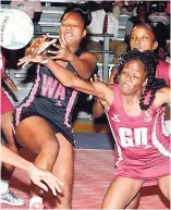  ?? CONTRIBUTE­D ?? Kingston Hummingbir­ds wing attack Melissa Mills (left) challenges St James Sharpes goal defender Sasha Dixon (front right) for the ball during their Berger Elite League netball match at the Leila Robinson Courts on Tuesday.