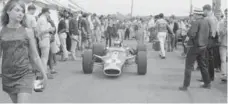  ?? NORRIS MCDONALD FOR THE TORONTO STAR ?? Two-time world champion Jim Clark drives through the paddock at Mosport Park in August 1967 (the F1 “garage” was a big circus tent).