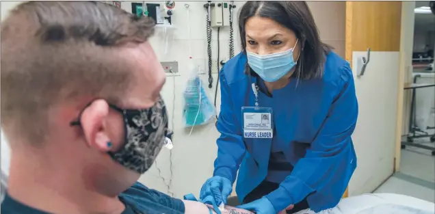  ??  ?? Judi Cruz provides care to a patient at The Hospital of Central Connecticu­t.