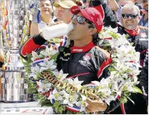  ?? ROBERT LABERGE / GETTY IMAGES ?? Juan Pablo Montoya celebrates after winning the 99th running of the Indianapol­is 500. The 15-year span between Montoya’s two Indy 500 victories is the longest in race history.