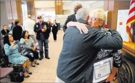  ?? K.M. Cannon ?? Las Vegas Review-journal @Kmcannonph­oto Charm Mcelree, of Boulder City, who volunteers with Operation Recognitio­n, gets a hug from Vietnam War veteran David Derose during a ceremony Thursday.