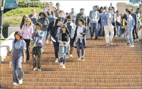  ?? Genaro Molina Los Angeles Times ?? VISITING students walk down UCLA’s Janss Steps on a campus tour. The school is reviewing admissions decisions in light of the scandal.