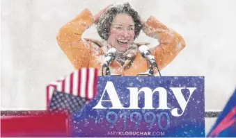  ?? ANTHONY SOUFFLE/STAR TRIBUNE VIA AP ?? Democratic U.S. Sen. Amy Klobuchar brushes snow from her hair Sunday at Boom Island Park in Minneapoli­s after announcing she is running for president.