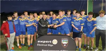  ?? Pic: Eamonn McMunn. ?? Calry/St Joseph’s team receive the Expert Electrical Minor C Championsh­ip Shield from Padraig Clancy. They defeated Castleconn­or by 3-14 to 1-8 in the final.