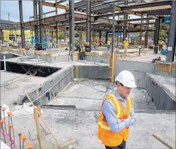  ?? Jay L. Clendenin Los Angeles Times ?? THE PROJECT, known as Palisades Village, is envisioned as more of a walkable Main Street than a ritzy shopping center similar to the Grove. Above, executive Michael Gazzano at the site in Pacific Palisades.