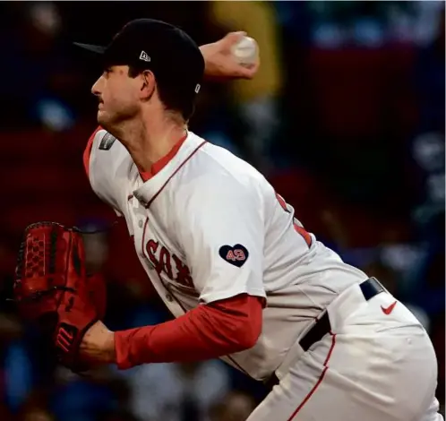  ?? BARRY CHIN/GLOBE STAFF ?? Sox starter Garrett Whitlock allowed two runs but went just four innings, exiting with left oblique tightness.