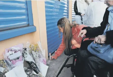  ??  ?? Mourners leave flowers outside Tipu Sultan’s takeaway where he was shot dead.