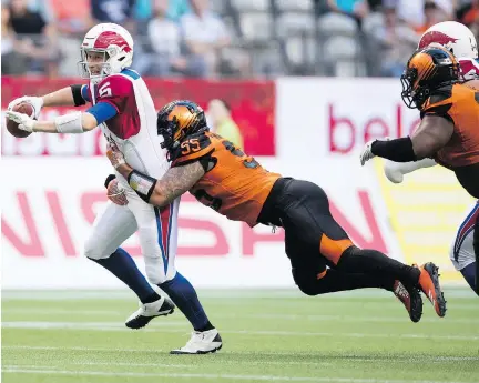  ?? DARRYL DYCK/THE CANADIAN PRESS ?? Montreal Alouettes quarterbac­k Drew Willy is sacked by the B.C. Lions’ Gabriel Knapton during the first-half of Saturday’s season opener in Vancouver. Willy completed 25 of 35 for 281 yards in a 22-10 losing cause to the Lions.