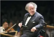  ?? MICHAEL DWYER — ASSOCIATED PRESS FILE ?? James Levine conducts the Boston Symphony Orchestra at Tanglewood in Lenox, Mass., in July 2006.