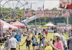  ?? Paul Buckowski / Times Union archive ?? Families make their way through the Washington County Fair back in Aug. 2019 in Greenwich.