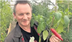  ??  ?? Hot stuff Alasdair Forsyth with his Carolina Reaper chilli