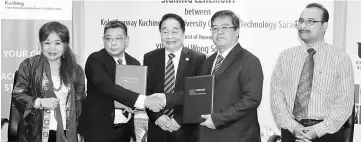  ??  ?? Lim (second left) and Hakim shaking hands after the MoU signing, witnessed by Wong (centre). Also seen are Cheah (left) and Zainal. — Photo by Jeffery Mostapa