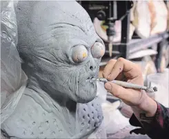  ??  ?? Steve Bellamy sculpts the prototype for an alien mask in his Stoney Creek workshop. He has made masks for film studios, rock bands and private collectors.