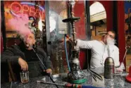  ?? Santiago Mejia/The Chronicle 2018 ?? Khaled Shehadeh and Adnan Abu Sharkh smoke in S.F. Hookah items would be exempt from Prop. 31.