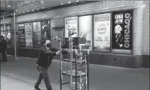  ?? MARK LENNIHAN / AP ?? A New Yorker moves lighting equipment through Shubert Alley on the way to a Broadway theater on May 6.