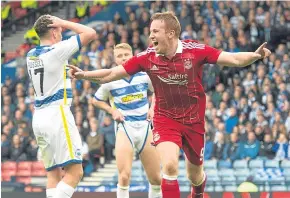  ?? Picture: SNS Group. ?? Adam Rooney wheels away after putting Aberdeen ahead with a disputed header.