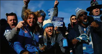  ?? EMILY ELCONIN/THE NEW YORK TIMES ?? Detroit Lions fans celebrate during a tailgate party Sunday at Eastern Market, a collection of shops and restaurant­s near Ford Field in Detroit. The club’s playoff run has provided much joy and a boost for local businesses.