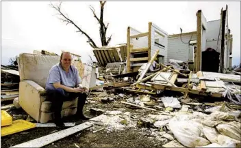  ?? BRETT CARLSEN GETTY IMAGES ?? Laura Cercone takes a break Wednesday from going through the remains of her friend’s house where all family members survived the tornado with minor or no injuries in Cookeville, Tenn.