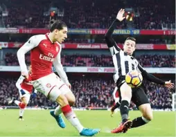  ?? Arsenal’s Hector Bellerin crosses the ball past Newcastle United’s Spanish midfielder Javier Manquillo during the English Premier League match between Arsenal and Newcastle United at the Emirates Stadium ??