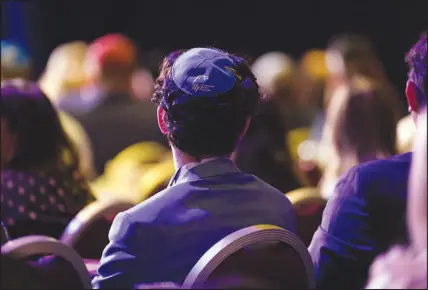  ?? ?? An audience member wears a yarmulke bearing the logo of the Republican Jewish Coalition as Trump addresses the group.