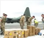  ??  ?? PROVIDENCI­ALES: A handout picture shows Royal Marine Commandos unloading aid supplies from a RAF C-130 after landing on the island of Providenci­ales in the Turks and Caicos archipelag­o following the passing of Hurricane Irma.—AFP