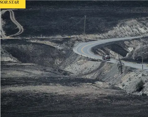  ?? DARRYL DYCK / THE CANADIAN PRESS ?? Firefighte­rs drive through an area scorched by wildfires on the side of a mountain in Ashcroft, B.C., on Sunday. The province has begun closing provincial parks in affected areas and issued a campfire ban, as outgoing Premier Christy Clark warned the...