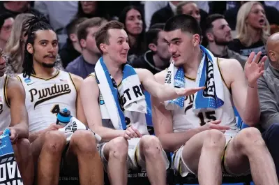  ?? (AP photo/michael Conroy) ?? Purdue forward Trey Kaufman-renn, from left, guard Fletcher Loyer and center Zach Edey watch from the bench in the second half of a first-round college basketball game Friday against Grambling State in the NCAA Tournament in Indianapol­is. Purdue won 78-50.