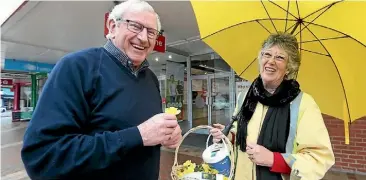  ??  ?? Kathryn Nicholls receives a donation from Paul Corbett on Daffodil Day last year.